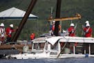 The duck boat that sank in Table Rock Lake in Branson, Mo., is raised Monday, July 23, 2018. The boat went down Thursday evening after a thunderstorm 