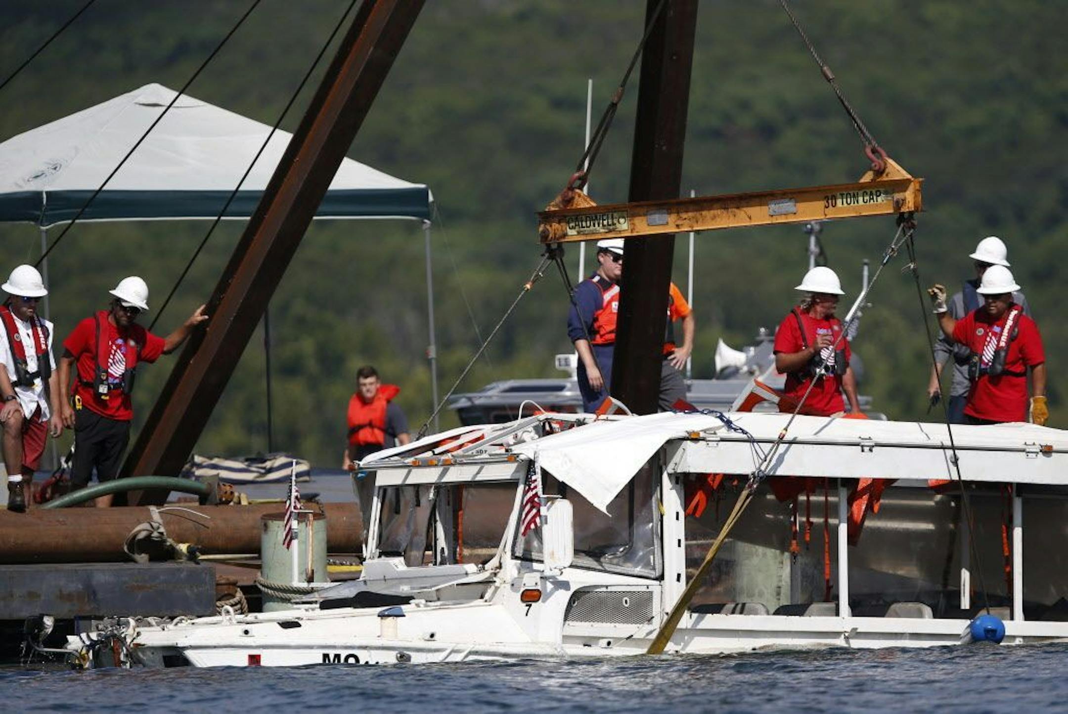 The duck boat that sank in Table Rock Lake in Branson, Mo., is raised Monday, July 23, 2018. The boat went down Thursday evening after a thunderstorm generated near-hurricane strength winds.