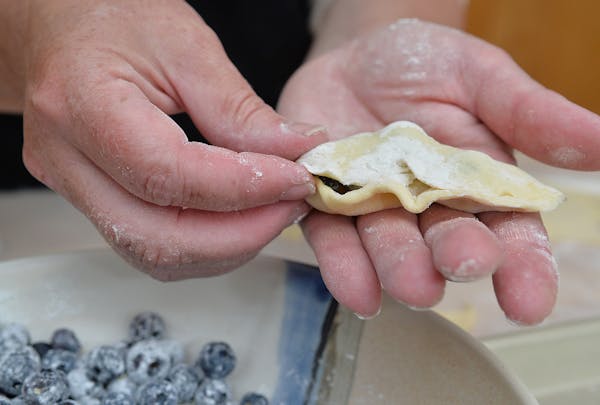 Pinch the edges of the dough closed to create the pierogie pillow. ] (SPECIAL TO THE STAR TRIBUNE/BRE McGEE)