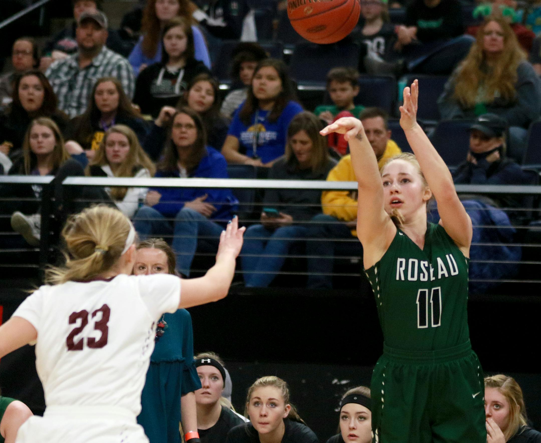 Roseau's Kacie Borowicz (11) hits a three point shot while covered by Sauk Centre's Maesyn Thiesen (23) during the second half of Sauk Centre's 63-52 win over Roseau in the 2A girls' basketball state championships Saturday, March 17, 2018, at Target Center in Minneapolis, MN.] DAVID JOLES • david.joles@startribune.com Lyle-Pacelli and Sleepy Eye 1A girls' basketball state championships