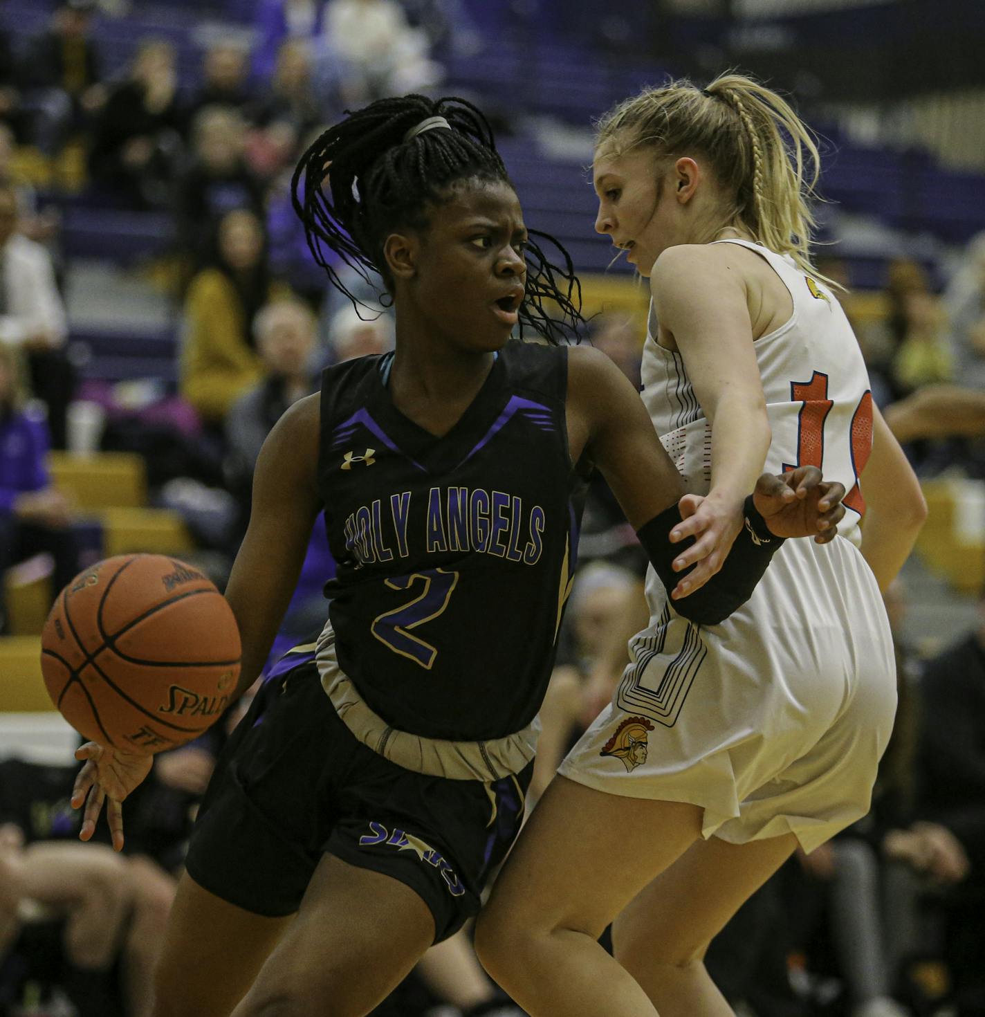 Grace Massaquoi (2) drives around Orono's Kaila Youngs during a Class 3A Section 6 girls' basketball championship game at Chanhassen. Massaquoi scored a game-high 23 points off the bench to lead Holy Angels to a 72-50 victory. Photo by Mark Hvidsten, SportsEngine