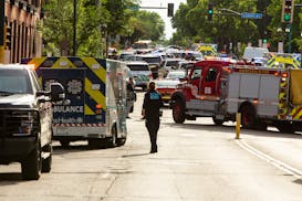Law enforcement and first responders converge near the scene of a fatal shooting in south Minneapolis on Thursday.