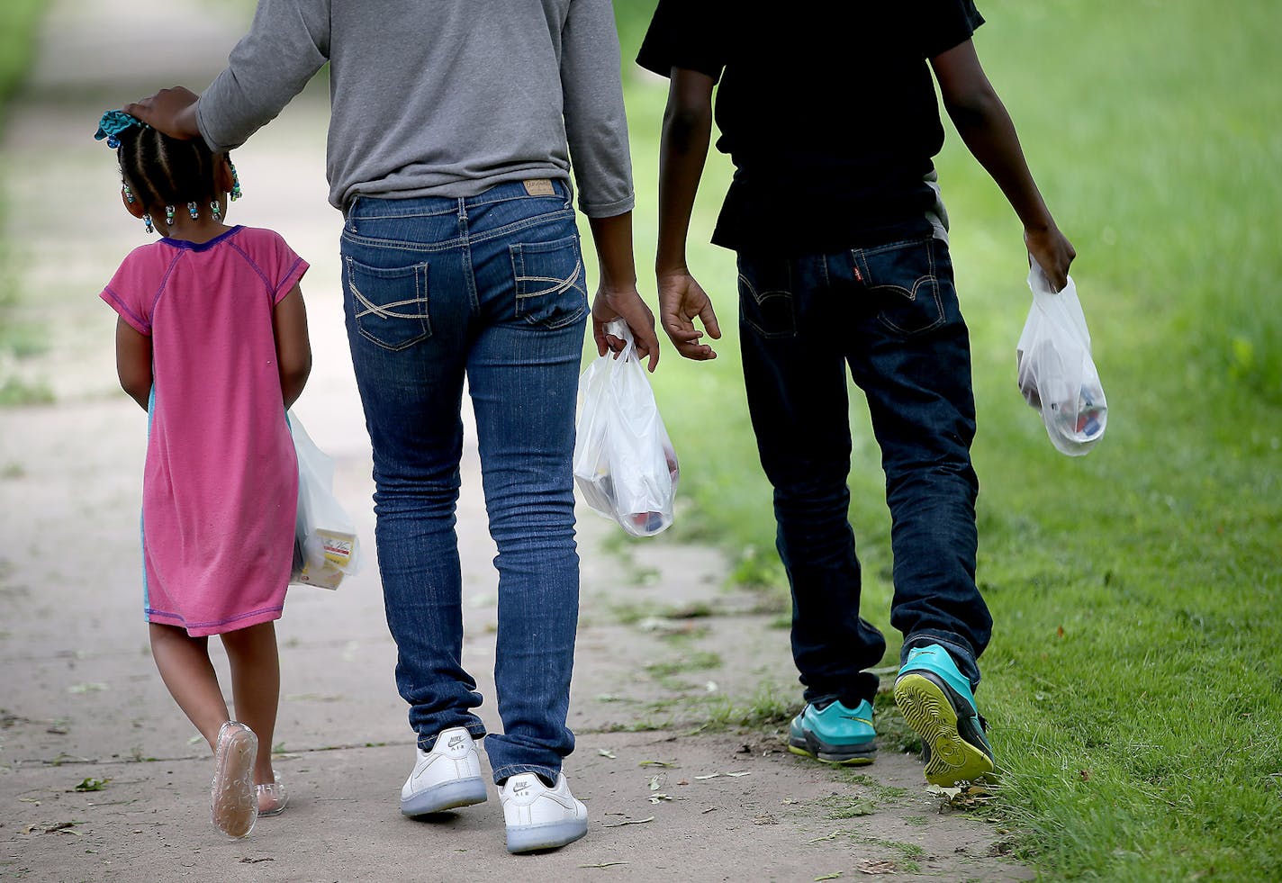 Kids made their way down a sidewalk near the Minnehaha Apartments after receiving a meal from the St. Paul school district&#x2019;s first-ever summer food truck. The truck, purchased a year ago with $25,000 in grant money, will make several stops per day in the city through August 28. Three meals will be served daily between 10 a.m. and 5:30 p.m.