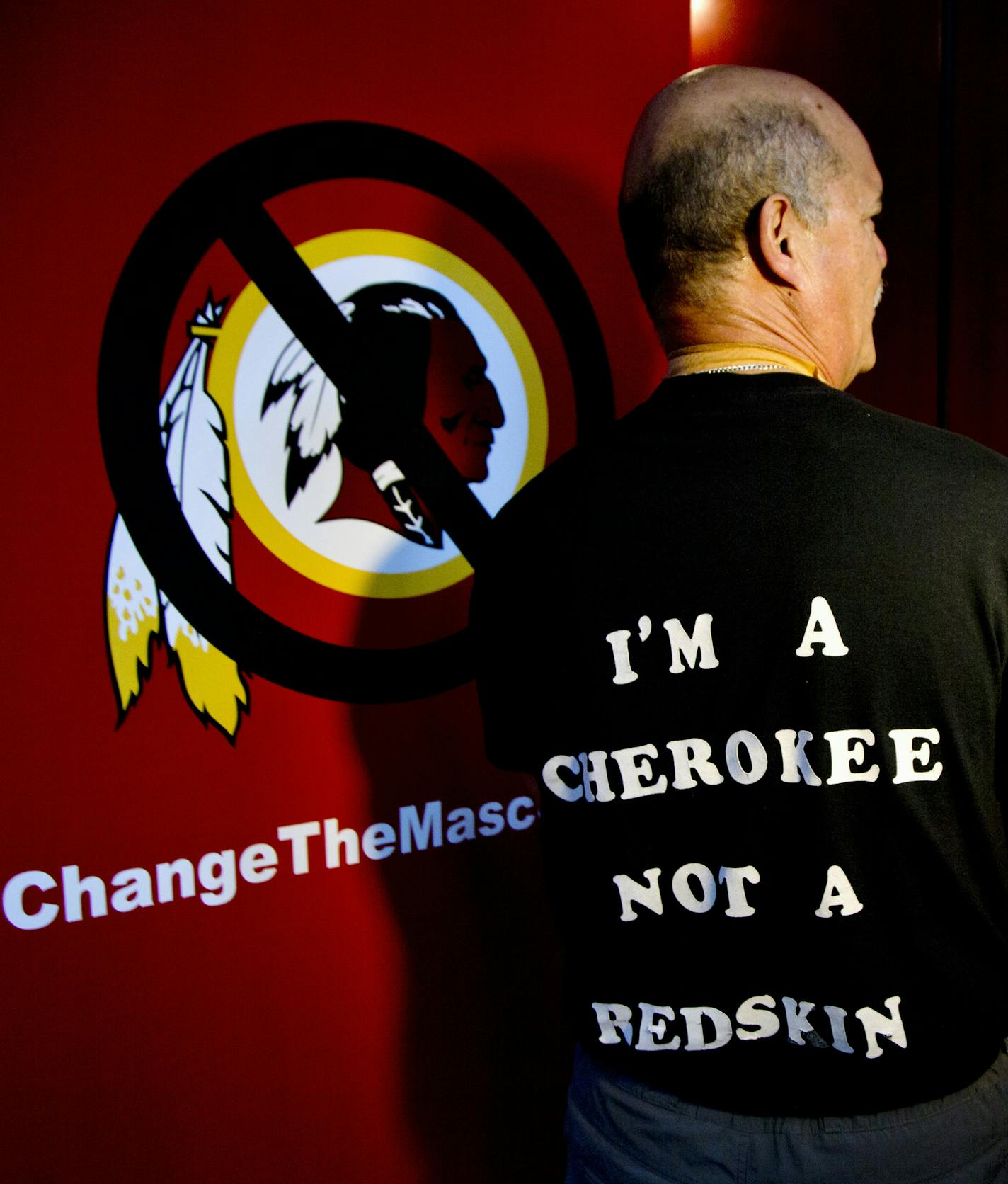 Verlin Deer In Water, a member of the Cherokee Nation of Oklahoma shows his t-shirt during an interview in Washington, Monday, Oct. 7, 2013, calling for the Washington Redskins NFL football team to change its name, prior to the start of the Oneida Indian Nation's Change the Mascot symposium. During an interview, President Barack Obama suggested that the owner of the Washington Redskins football team consider changing its name because, the president said, the current name offends "a sizable group