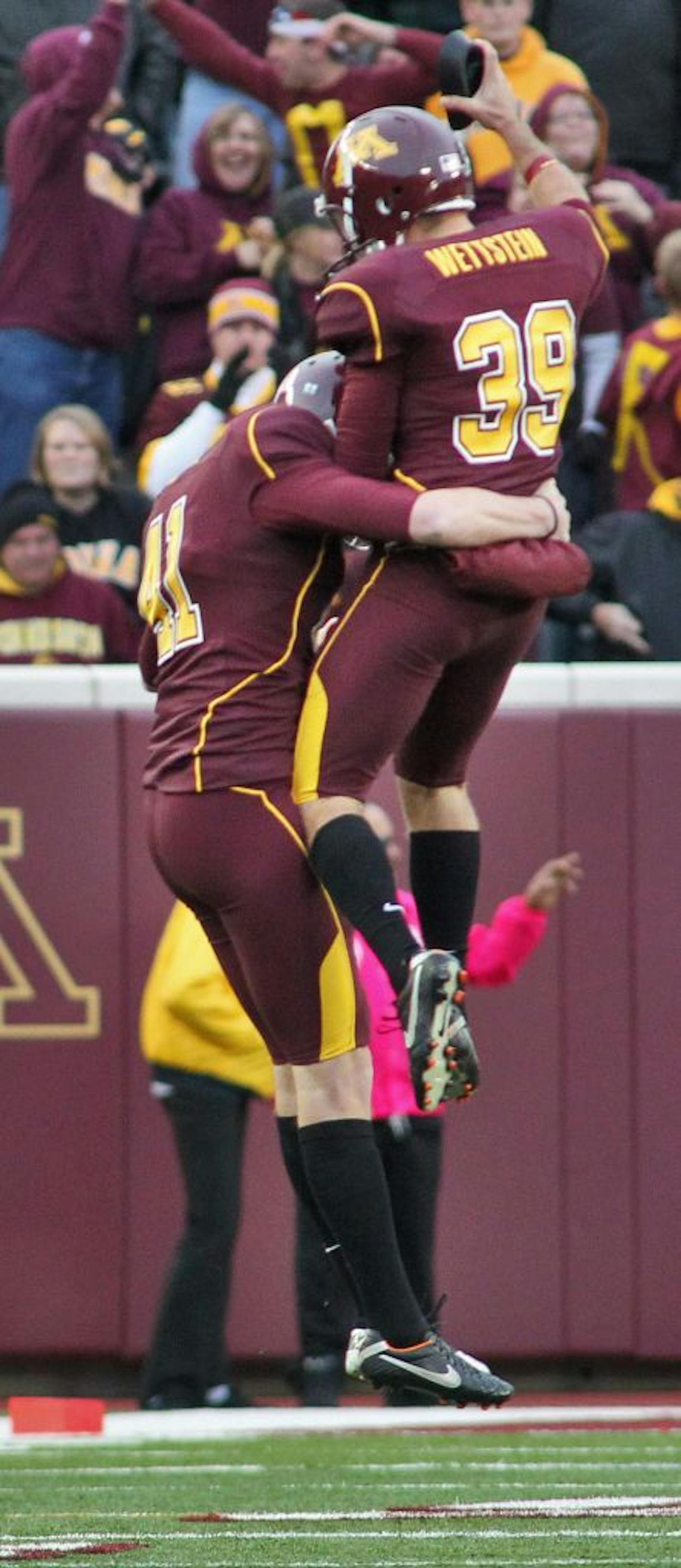 Gophers kicker Jordan Wettstein (39) celebrated with punter Dan Orseske executing a fourth-quarter onside kick that led to the winning score against Iowa on Saturday.