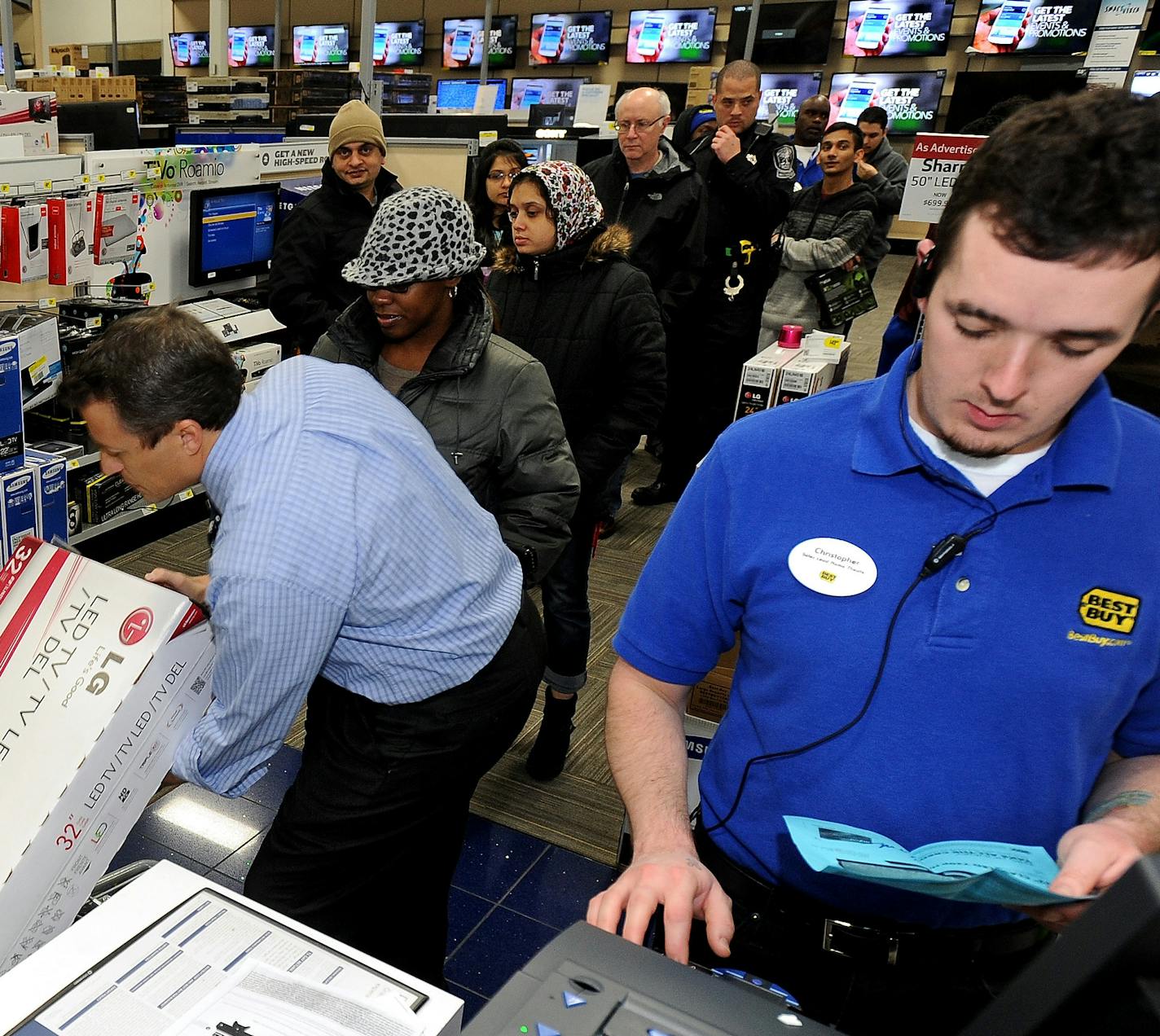 FILE - In this Nov. 29, 2013, file photo, Best Buy employee Christopher Gervais, right, rings up a 32-inch LED TV in Dunwoody, Ga. Sales at U.S. stores dropped 3.1 percent to $42.7 billion for the week that ended on Sunday, Dec. 22, 2013, compared with the same week last year, according to ShopperTrak, which tracks data at 40,000 locations. (AP Photo/David Tulis, File)