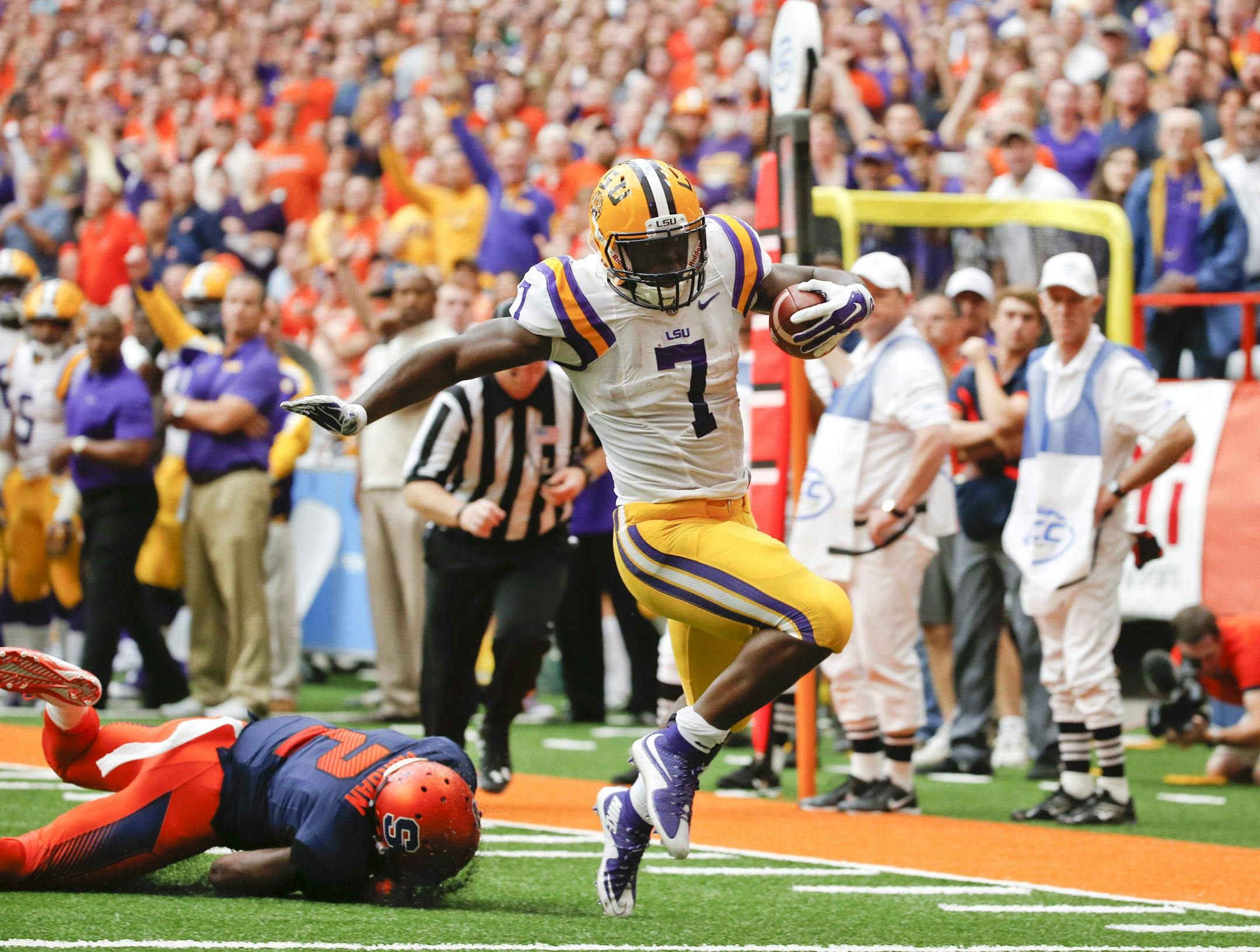 LSU running back Leonard Fournette (7) gets past Syracuse cornerback Wayne Morgan (2) for a touchdown in the first half of an NCAA college football game, Saturday, Sept. 26, 2015, in Syracuse, N.Y. Leonard Fournette ran for a career-high 244 yards and two touchdowns in their 34-24 win. (AP Photo/Mike Groll)