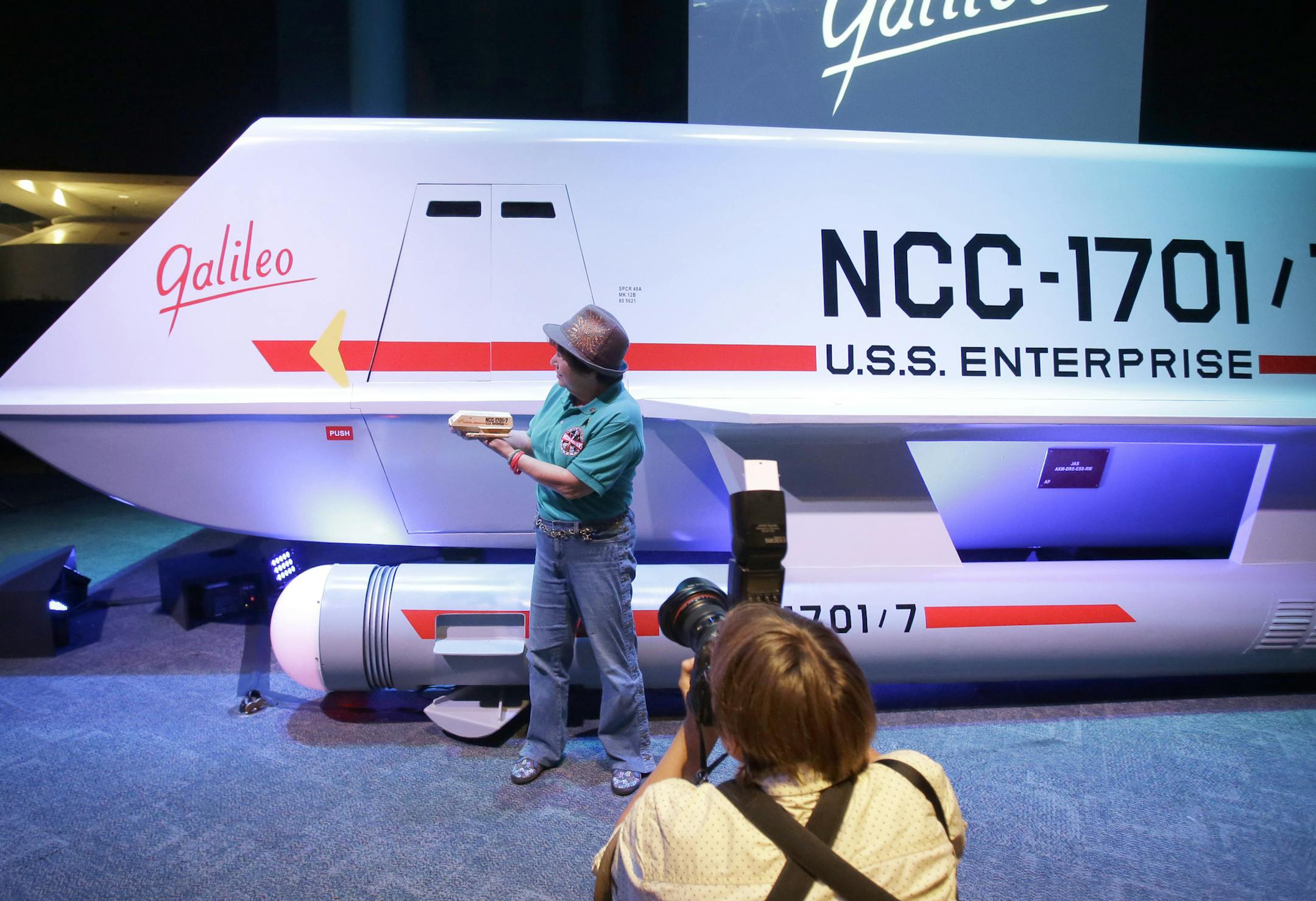 Candy Torres is photographed standing in front of the restored space shuttle Galileo from the 1960's television show Star Trek holding her plastic toy version of the vehicle at Space Center Houston Wednesday, July 31, 2013, in Houston. The restored shuttlecraft that crash-landed on a hostile planet in the 1967 episode "The Galileo Seven" was officially unveiled at the Space Center Houston before a crowd of die-hard Star Trek fans. (AP Photo/Pat Sullivan)