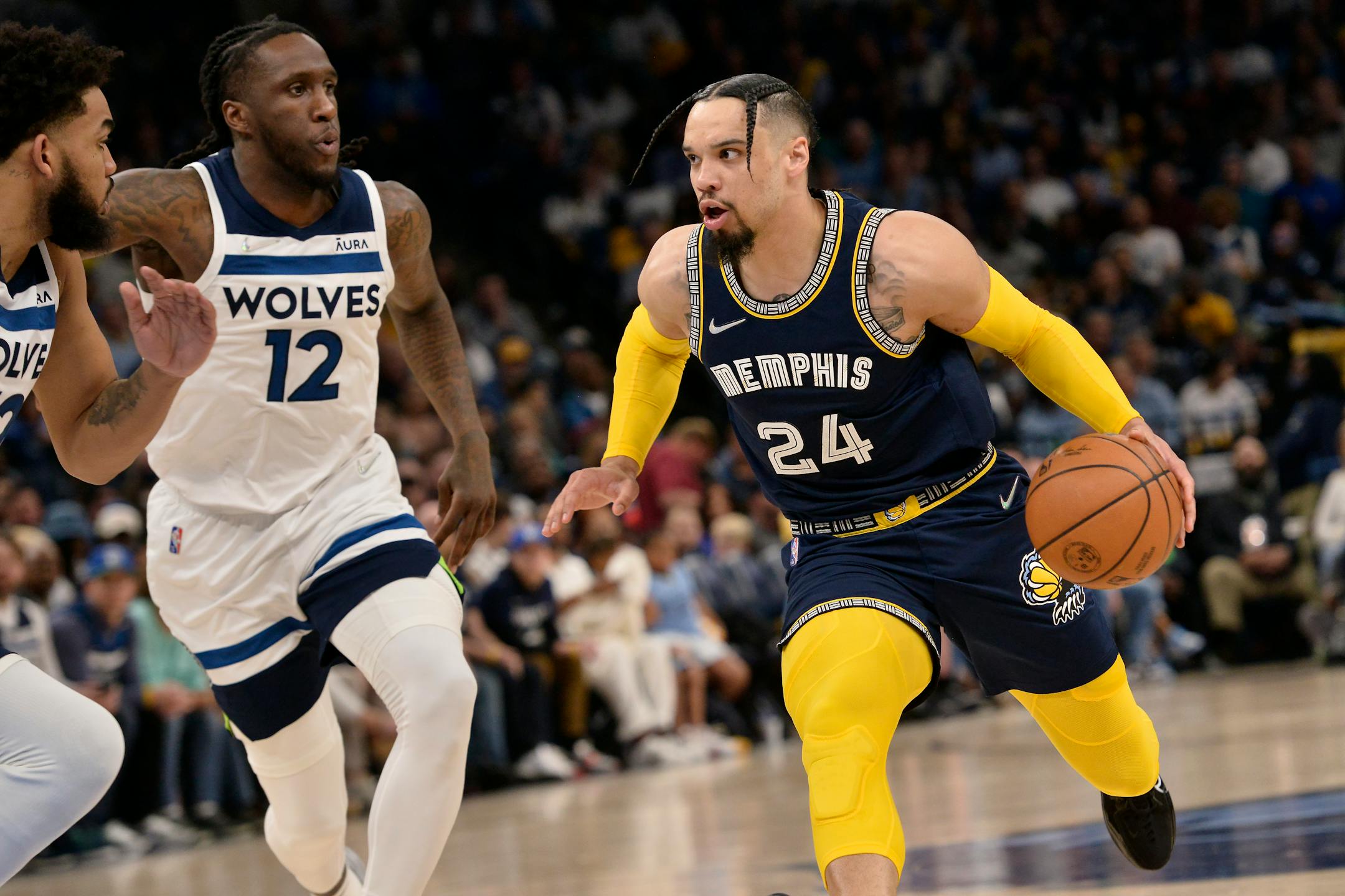 Memphis Grizzlies forward Dillon Brooks (24 drives against Minnesota Timberwolves forward Taurean Prince (12) during the first half during Game 2 of a first-round NBA basketball playoff series Tuesday, April 19, 2022, in Memphis, Tenn. (AP Photo/Brandon Dill)