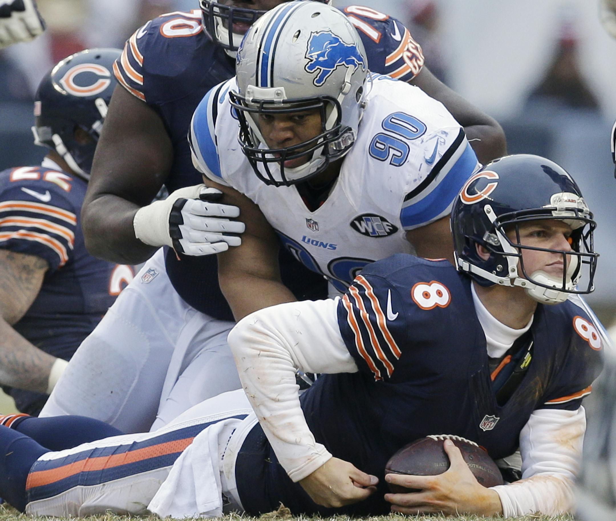 Chicago Bears quarterback Jimmy Clausen (8) is sacked by Detroit Lions defensive tackle Ndamukong Suh (90) in the second half of an NFL football game Sunday, Dec. 21, 2014, in Chicago. (AP Photo/Nam Y. Huh) ORG XMIT: CXB161