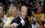 Former New York Gov. Eliot Spitzer is surrounded by media as he tries to collect signatures for his run for New York City Comptroller in New York, Mon