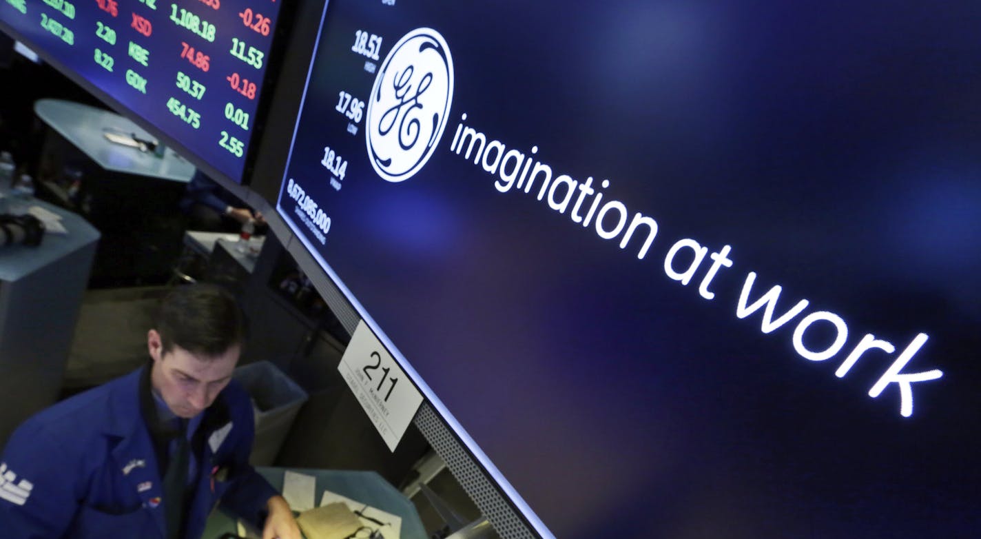 Specialist John McNierney works at the post that handles General Electric on the floor of the New York Stock Exchange, Tuesday, Jan. 16, 2018. GE CEO John Flannery, who was put in charge of reviving the company last summer, revealed significant issues at GE Capital on Tuesday, which will lead to a $6.2 billion after-tax charge in the fourth quarter. (AP Photo/Richard Drew)