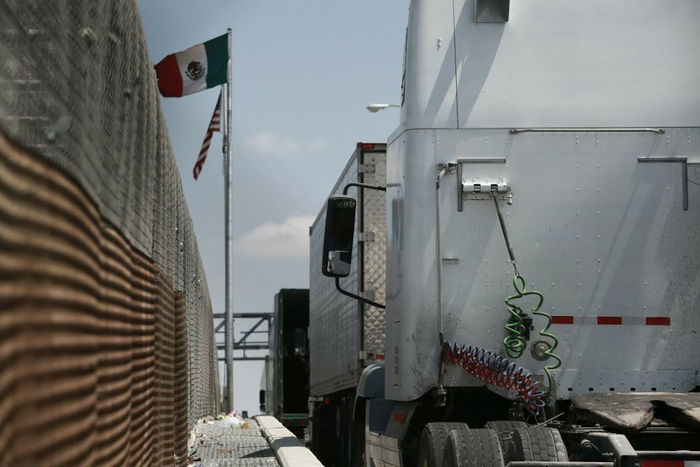 Trucks line up at the Corboba - LasAmericas international bridge to cross with their cargo from Mexico into the United States, in Ciudad Juarez, Mexico, Friday, May 31, 2019.