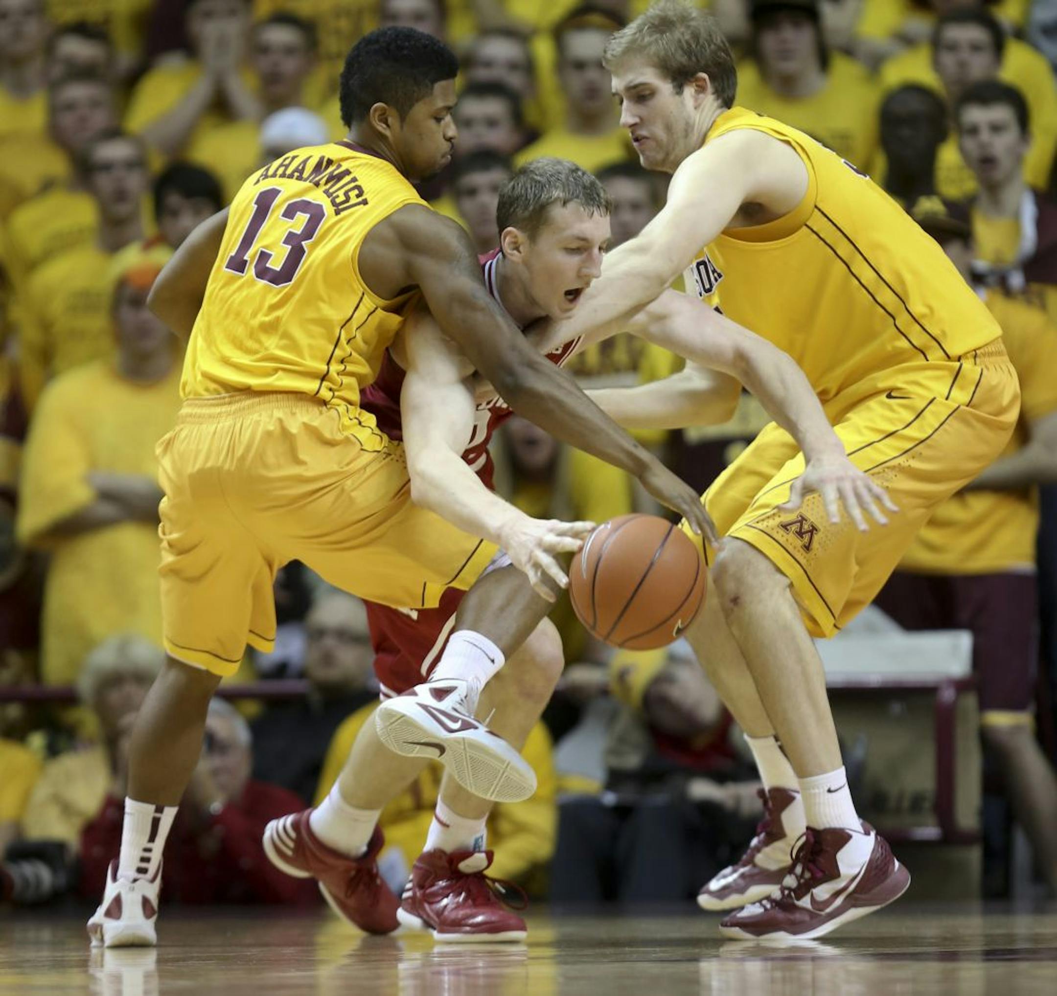 Gophers Maverick Ahanmisi (left) and Elliott Eliason double-teamed Indiana's Cory Zeller during the second half of Minnesota's 77-73 upset of the No. 1-ranked Hoosiers at Williams Arena on Tuesday.