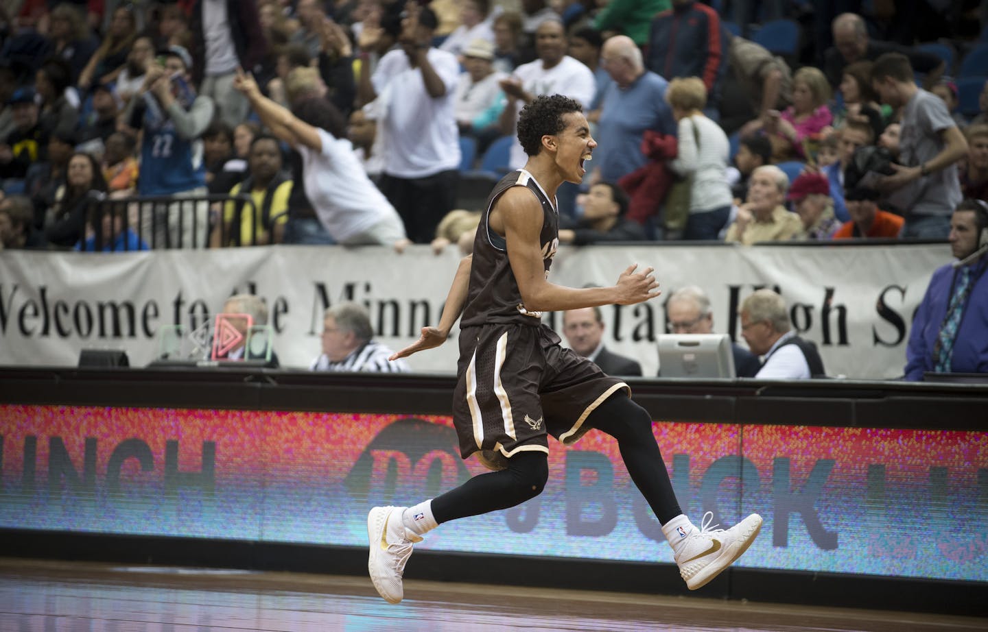 Apple Valley guard Tre Jones (3) rushes toward his brother, assistant coach Jadee Jones, to celebrate their victory over Champlin Park in the Class 4A boys' basketball championship. ] (Aaron Lavinsky | StarTribune) Champlin Park takes on Apple Valley in the Class 4A boys' basketball championship game on Saturday, March 14, 2014 at Target Center.