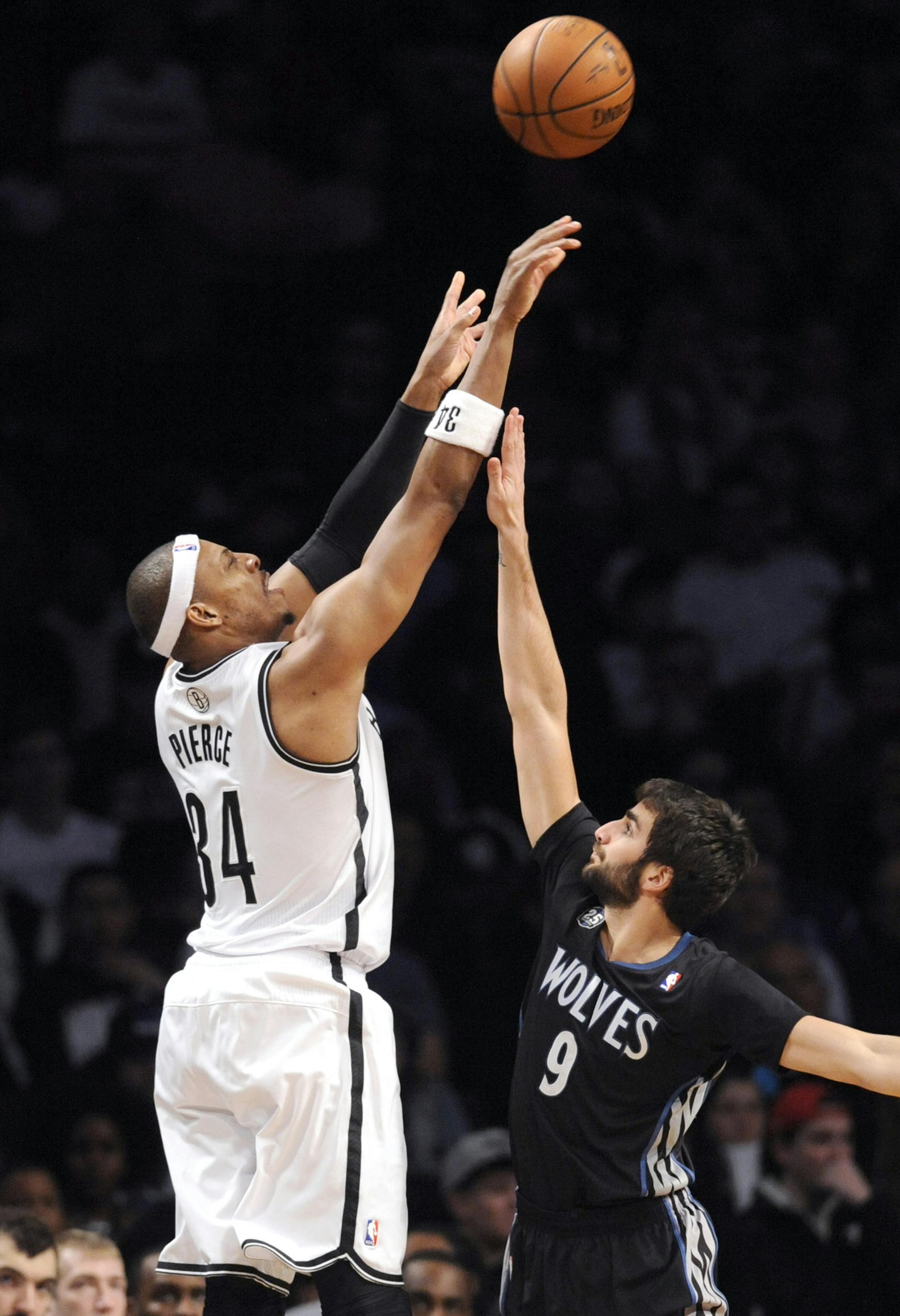 Brooklyn Nets' Paul Pierce, left, shoots over Minnesota Timberwolves' Ricky Rubio during the fourth quarter of an NBA basketball game on Sunday, March 30, 2014, at Barclay's Center in New York. The Nets won 114-99. (AP Photo/Bill Kostroun)