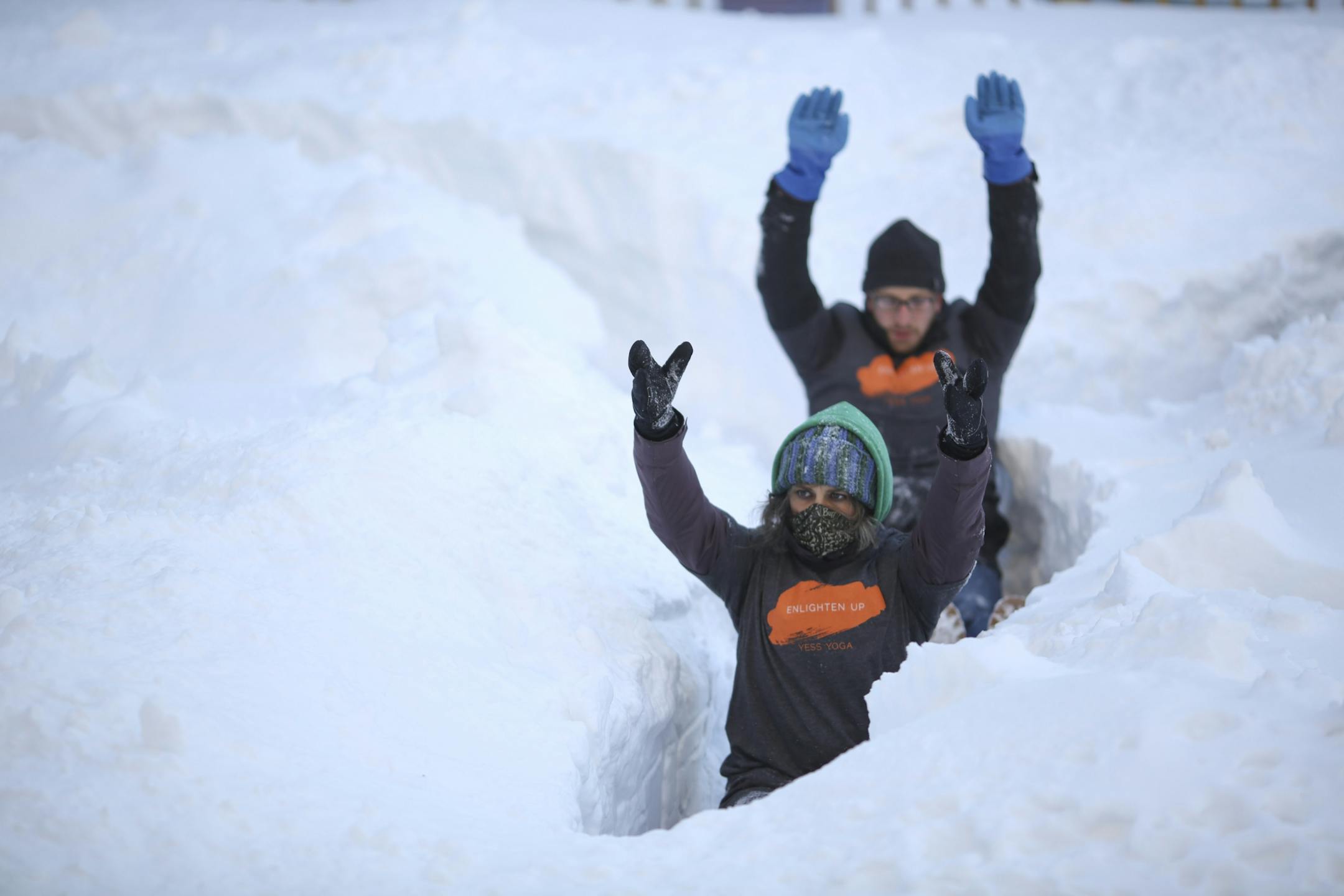They could be surrendering to to the winter, but Katherine Bisanz and Max Musicant were actually part of a group of a couple of dozen hardy souls who braved temperatures in the teens to practice yoga in the snow Sunday afternoon, February 23, 2014 on the Nicollet Mall in Minneapolis.