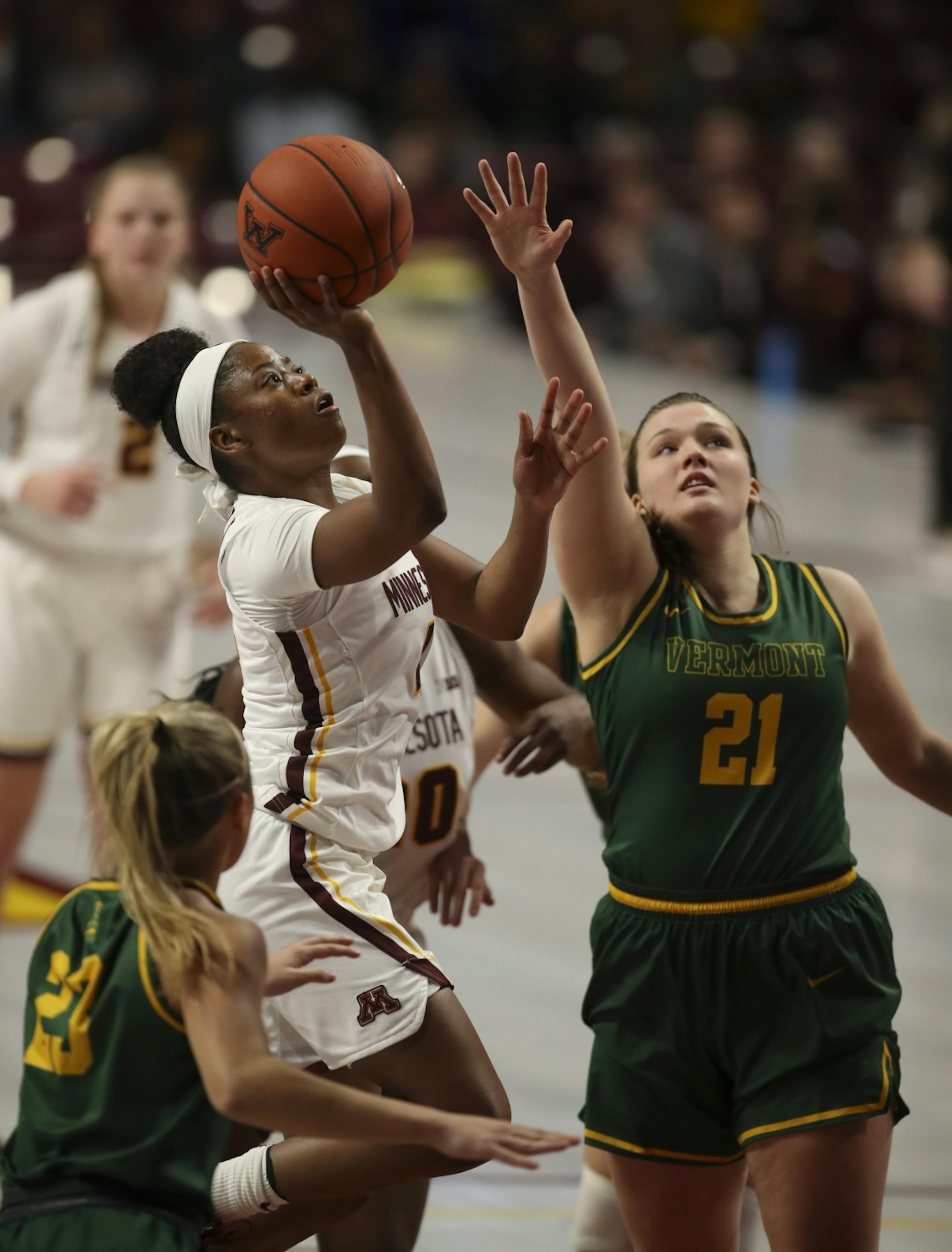 Minnesota Golden Gophers guard Jasmine Powell (4) put up two of her 19 points while defended by Vermont Catamounts guard Emma Utterback (23) and forward Carly Whiteside (21) in the second quarter.