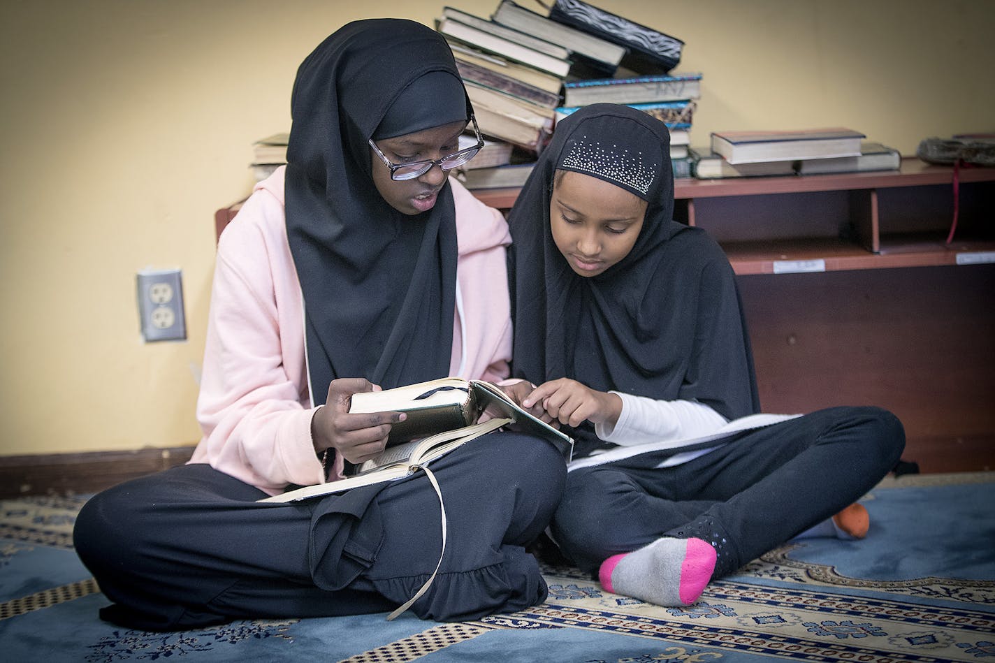 Wasima Farah, left, and Halima Adama, studied the Quran before prayer at the Dar Al Farooq Center, Friday, October 13, 2017 in Bloomington, MN. ] ELIZABETH FLORES &#xef; liz.flores@startribune.com