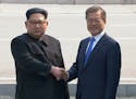 In this image taken from video provided by Korea Broadcasting System (KBS) Friday, April 27, 2018, North Korean leader Kim Jong Un, left, shakes hands