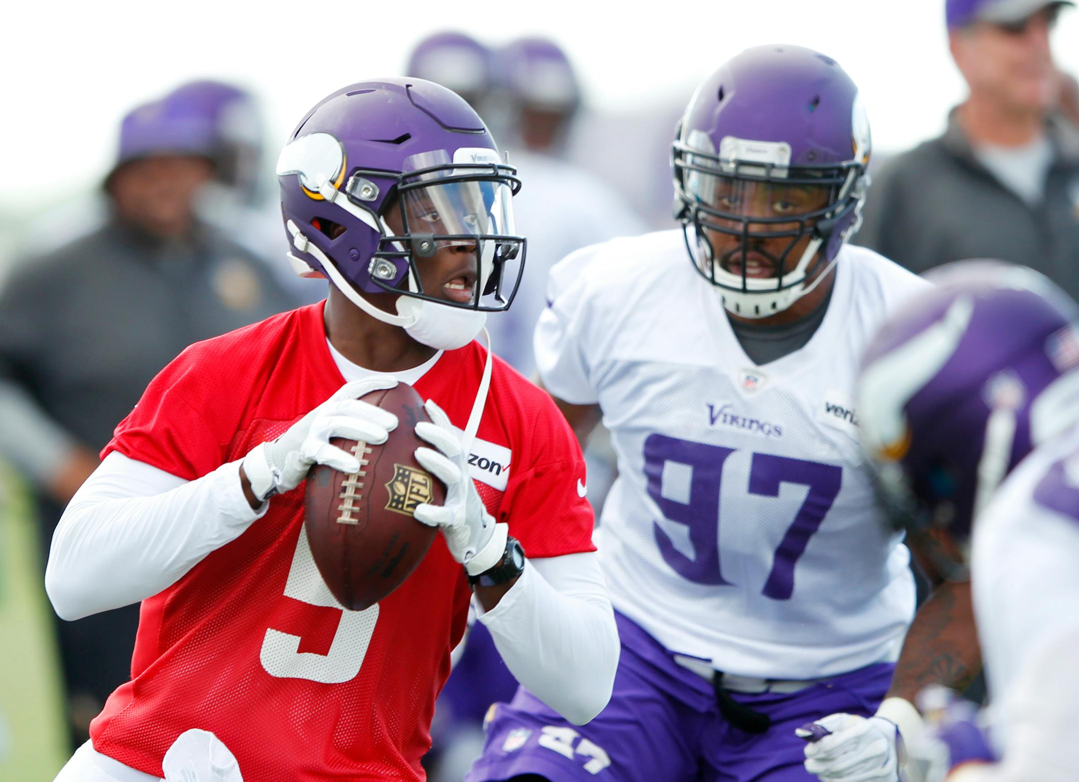 Minnesota Vikings quarterback Teddy Bridgewater (5) gets pressure from defensive end Everson Griffen (97) during the second day of the team's NFL football training camp at Mankato State University in Mankato, Minn., Saturday, July, 30, 2016. (AP Photo/Andy Clayton-King)