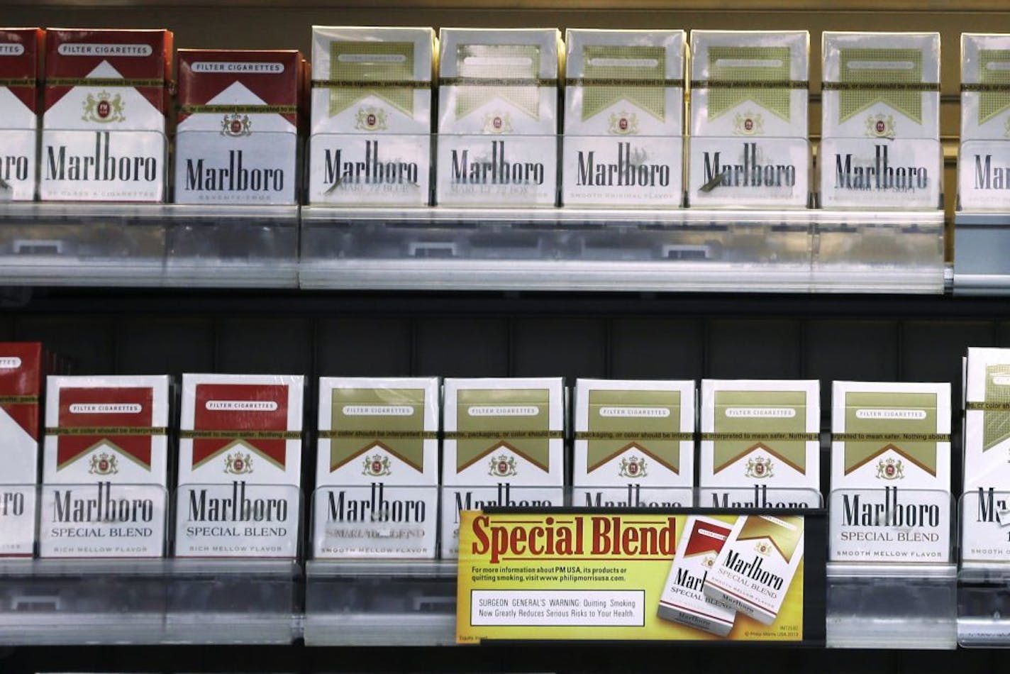 FILE - In this Wednesday, Oct. 23, 2013, file photo, Marlboro Gold and other Marlboro varieties of cigarettes are displayed in a Little Rock, Ark., store. Altria Group reports quarterly earnings on Thursday, Jan. 30, 2014.