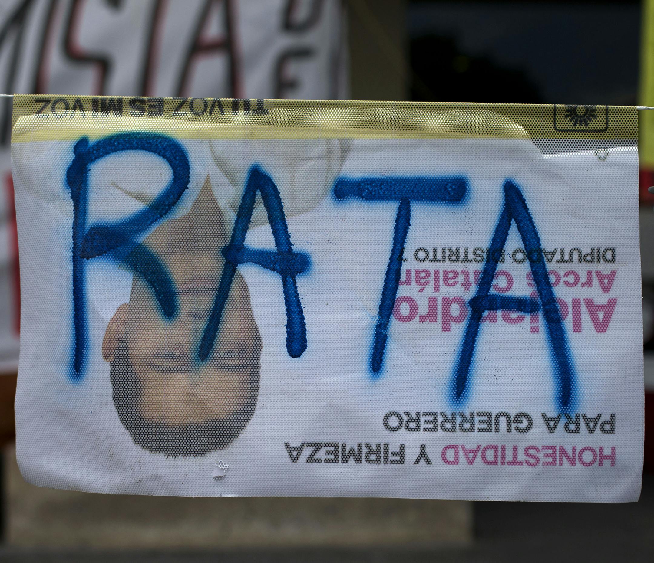 The word "Rat" is scrawled across an election poster hung upside down in the central square in Chilpancingo, capital of Guerrero State, Mexico, Thursday, June 4, 2015. Radical groups and unionized teachers in multiple Mexican states have vowed to block Sunday's voting for the lower house of congress, nine governorships and hundreds of mayorships. (AP Photo/Rebecca Blackwell)