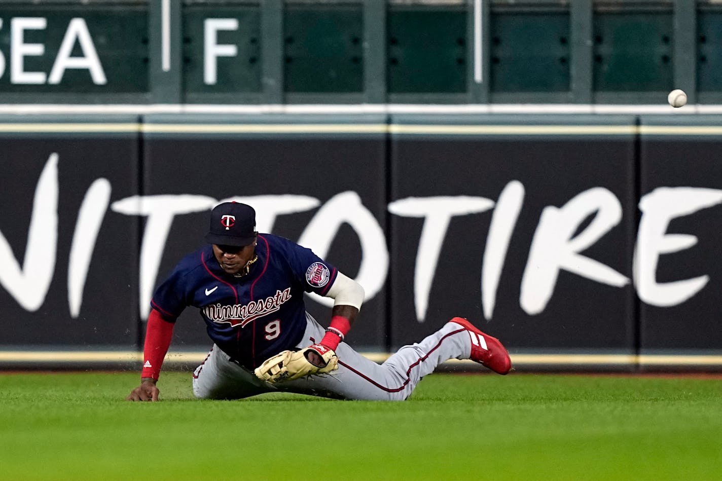 Minnesota Twins left fielder Tim Beckham tries to field a double by Houston Astros' Yordan Alvarez during the sixth inning of a baseball game Wednesday, Aug. 24, 2022, in Houston. (AP Photo/David J. Phillip)