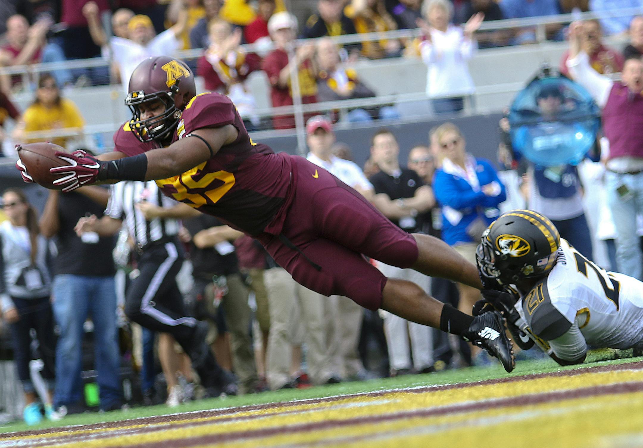 Minnestota running back Rodrick Williams Jr. dives into the endzone for a touchdown in front of Missouri's Ian Simon during the Buffalo Wild Wings Citrus Bowl at Citrus Bowl Stadium, Thursday, Jan. 1, 2015 in Orlando, Fla. Missouri won 33-17. (Jacob Langston/Orlando Sentinel/TNS) ORG XMIT: 1162151