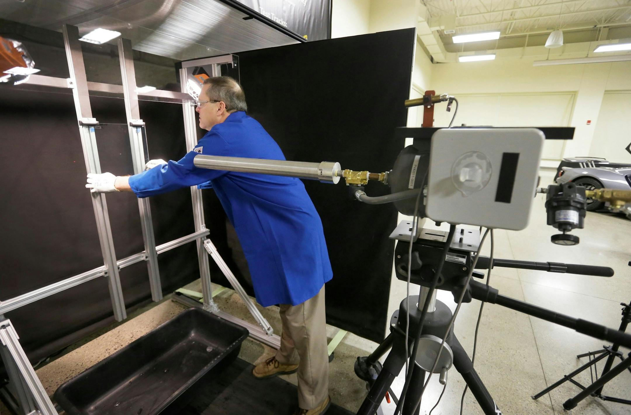 In a photo from Dec. 14, 2015, Tim Huten, Corning mechanical engineer sets up a test using Corning Inc.'s Gorilla Glass at the Dearborn Development Center in Dearborn, Mich. Gorilla Glass is found on billions of mobile phones and an automotive version will be used for the windshield and engine cover of the new Ford GT sports car. Ford says the glass is more durable and scratch-resistant than traditional glass. Itís also about 30 percent lighter, which saves fuel and improves the vehicle