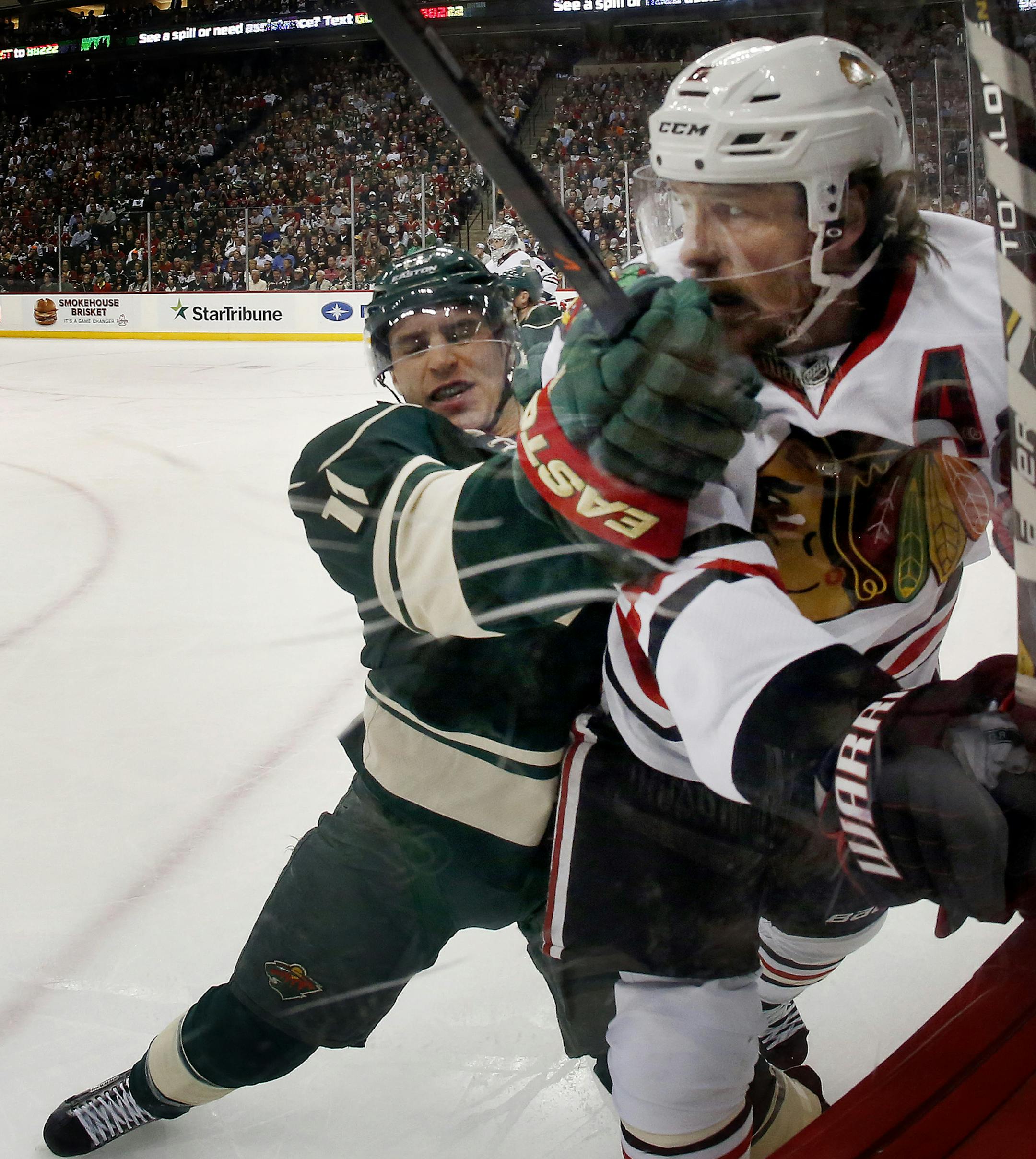 Zach Parise (11) and Duncan Keith (2) collided in the first period. ] CARLOS GONZALEZ cgonzalez@startribune.com - May 6, 2014, St. Paul, Minn., Xcel Energy Center, NHL, Minnesota Wild vs. Chicago Blackhawks, Stanley Cup Playoffs Round 2, Game 3