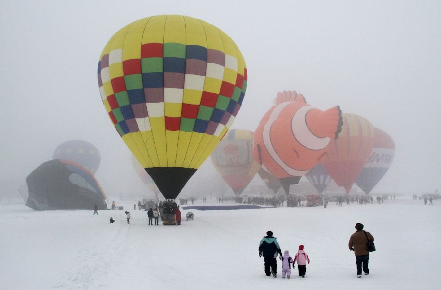 Jim and Susan Jacobs brought their three kids to Hudson, WI, to check out the field of balloons Saturday morning for Hudson's Hot Air Affair. The balloons were unable to fly due to foggy weather conditions.