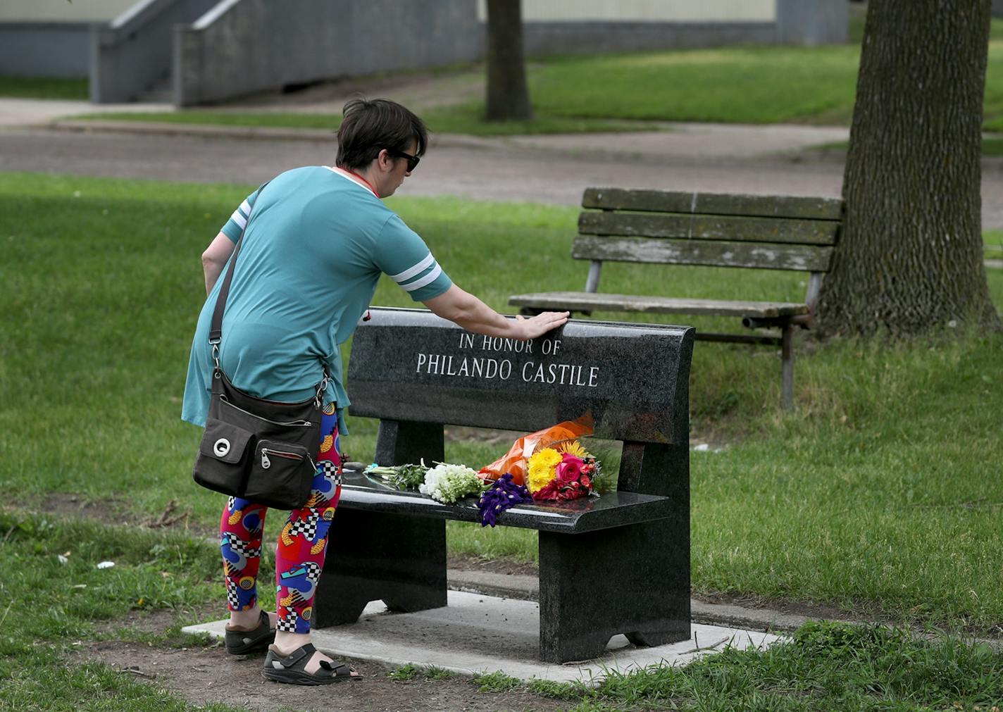 Amy Brisbane of St. Paul left a message and a rock on a memorial to Philando Castile outside the school where he worked.