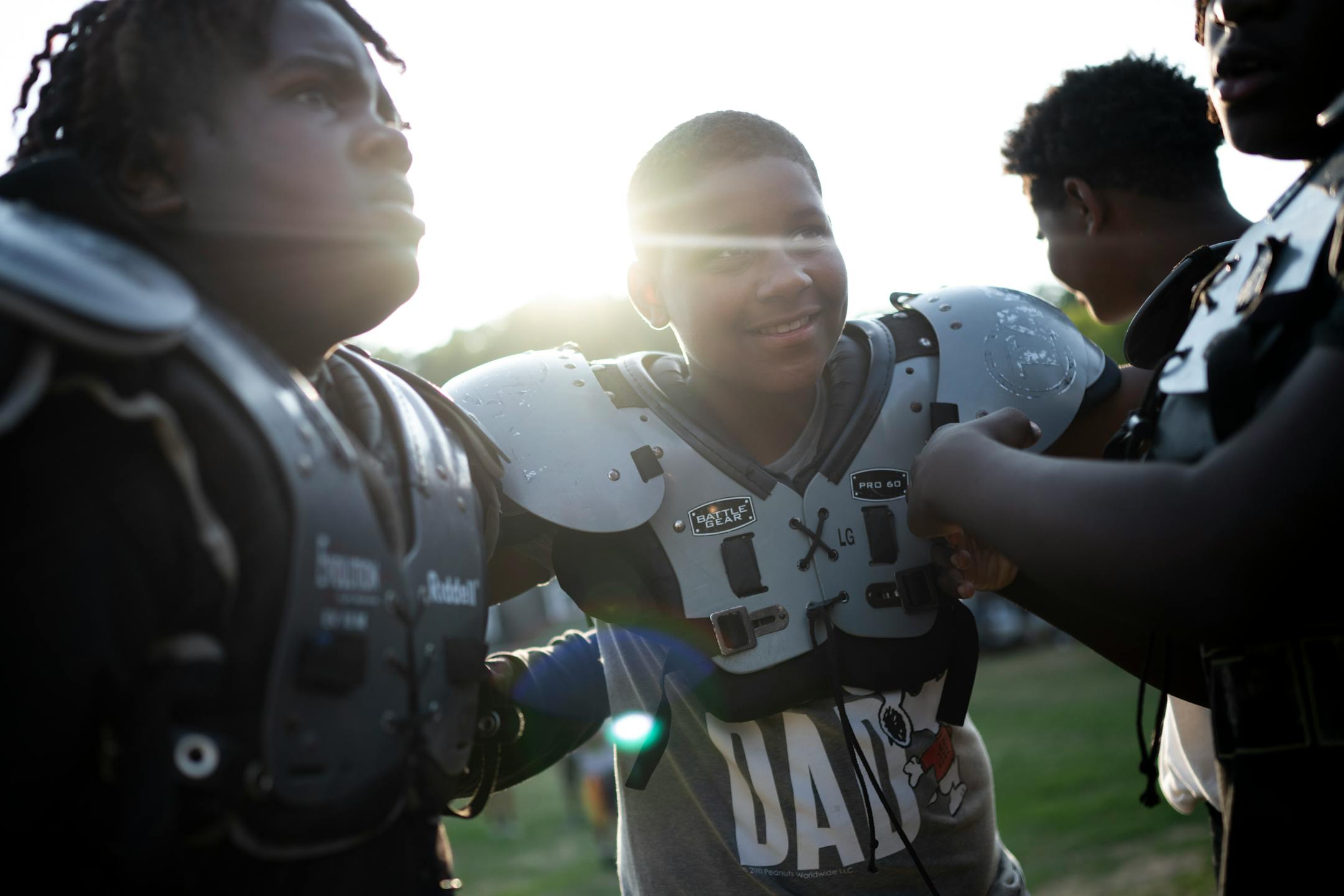 Jeremiah Shiner, 12, listens in a huddle with teammates. "I was really terrified," said Shiner, who was a witness to a shooting three years ago. "I didn't know what was happening."