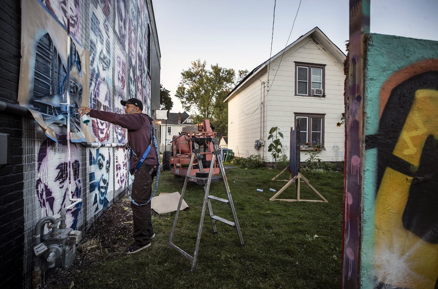 Profile of artist Peyton Scott Russell as he works on a elaborate mural at City of Lakes Community Land Trust that utilizes stencils that people created of themselves .] Jerry Holt •Jerry.Holt@startribune.com Profile of artist Peyton Scott Russell, who painted the massive George Floyd piece at 38th and Chicago. Russell is currently working on beautiful, elaborate mural at City of Lakes Community Land Trust that utilizes stencils that people created of themselves Thursday September 10,2020 in Min