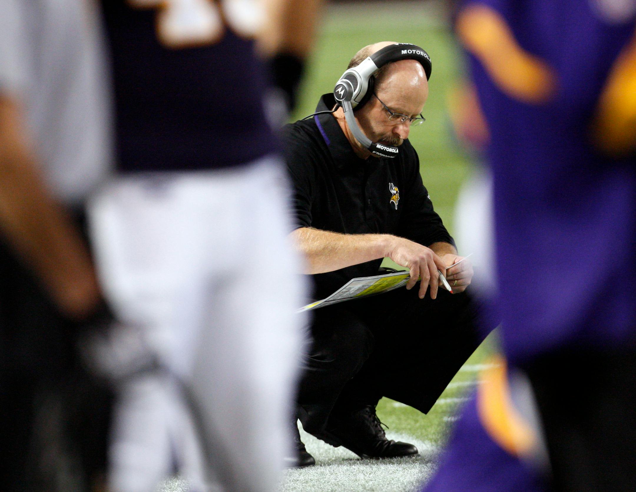 Minnesota Vikings coach Brad Childress studies his game notes during the second quarter of an NFL football game against the Detroit Lions in Minneapolis, Sunday, Oct. 12, 2008. The Vikings beat the Lions 12-10.