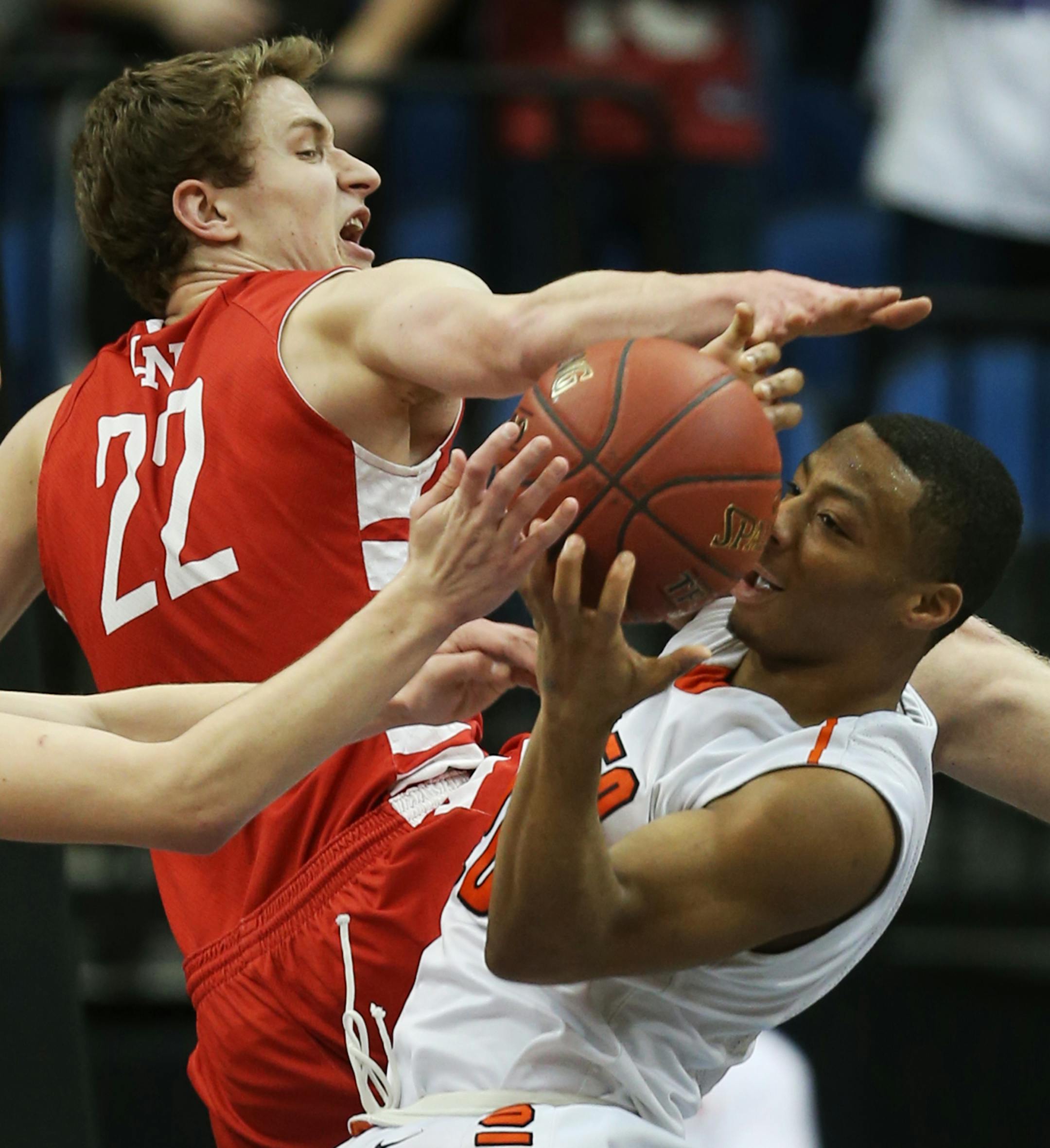 Kyle Williams(20) of Osseo tries to get control of the ball against Carter Brooks(22).] At Target Center in 4A quarterfinal game between Osseo H.S. and Lakeville North H.S. Richard Tsong-Taatarii/rtsong-taatarii@startribune.com