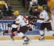 St. Cloud defenseman Niklas Nevalainen (7) was first checked by University of Minnesota forward Ryan Norman (23) and then hit in the head by the Gophe