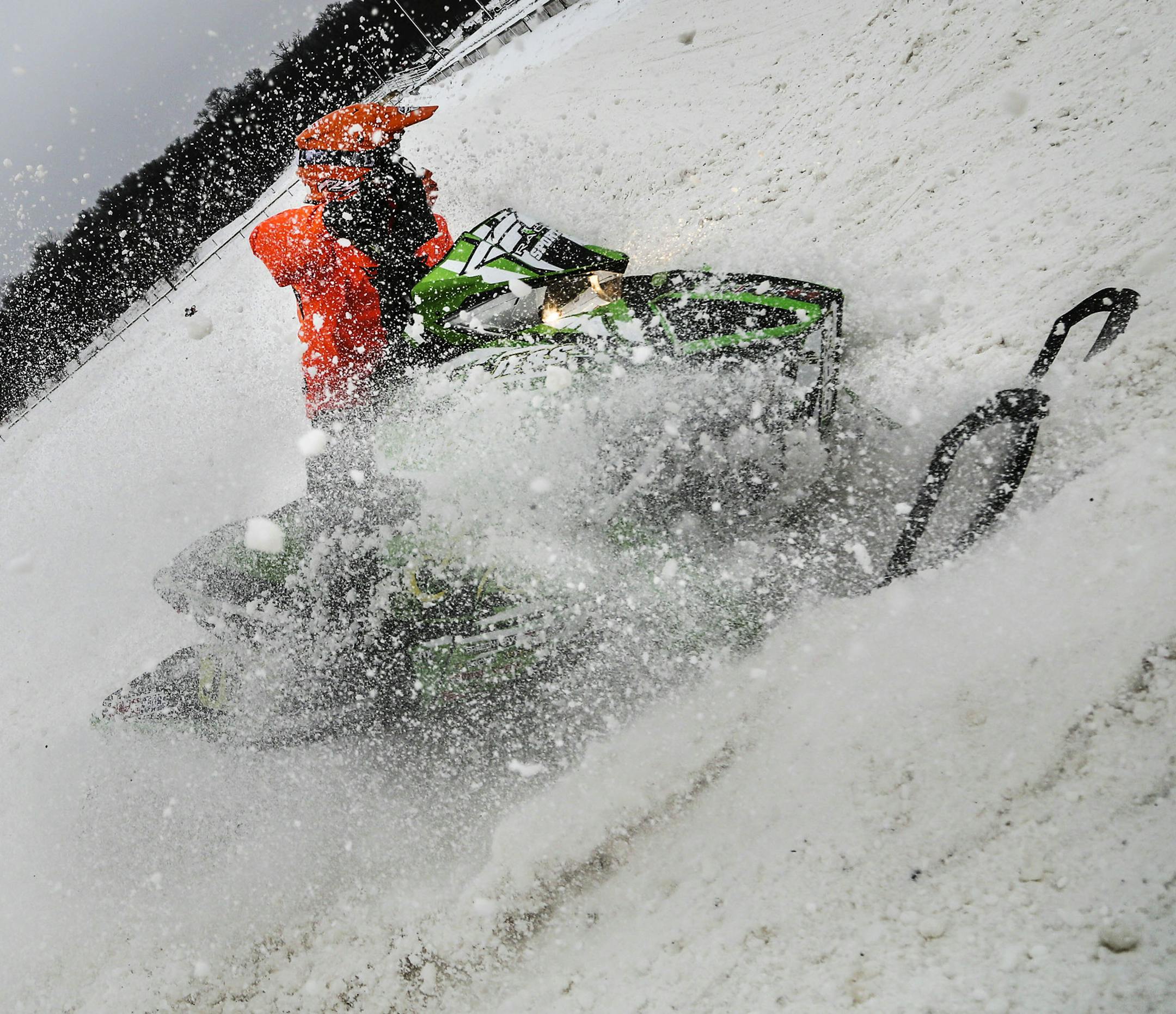 In the cold of winter ERX Motor Park in Elk River is a hotbed for snowcross, a type of snowmobile racing. Even on non-race days, up to 80 competitors plunk down up to $100 to practice on the course. Here, snow flies as a snocross competitor takes a corner while practicing Wednesday, Dec. 10, 2014, in Elk River, MN.](DAVID JOLES/STARTRIBUNE)djoles@startribune.com ERX Motor Park in Elk River is a hotbed for snowcross, a type of snowmobile racing. Even on non-race days, up to 80 competitors plunk d