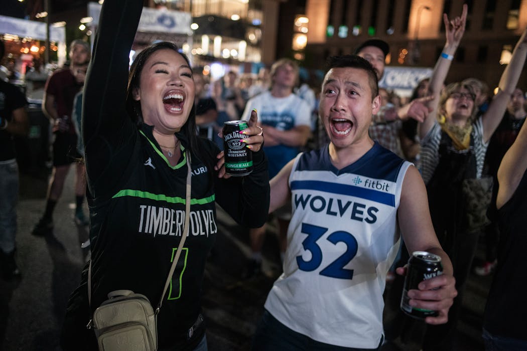 Fans Cindy Soukhanoupong and Bruce Oudavanh were among those watching the game at the Wolves Back Block Party across from Target Center Thursday night.
