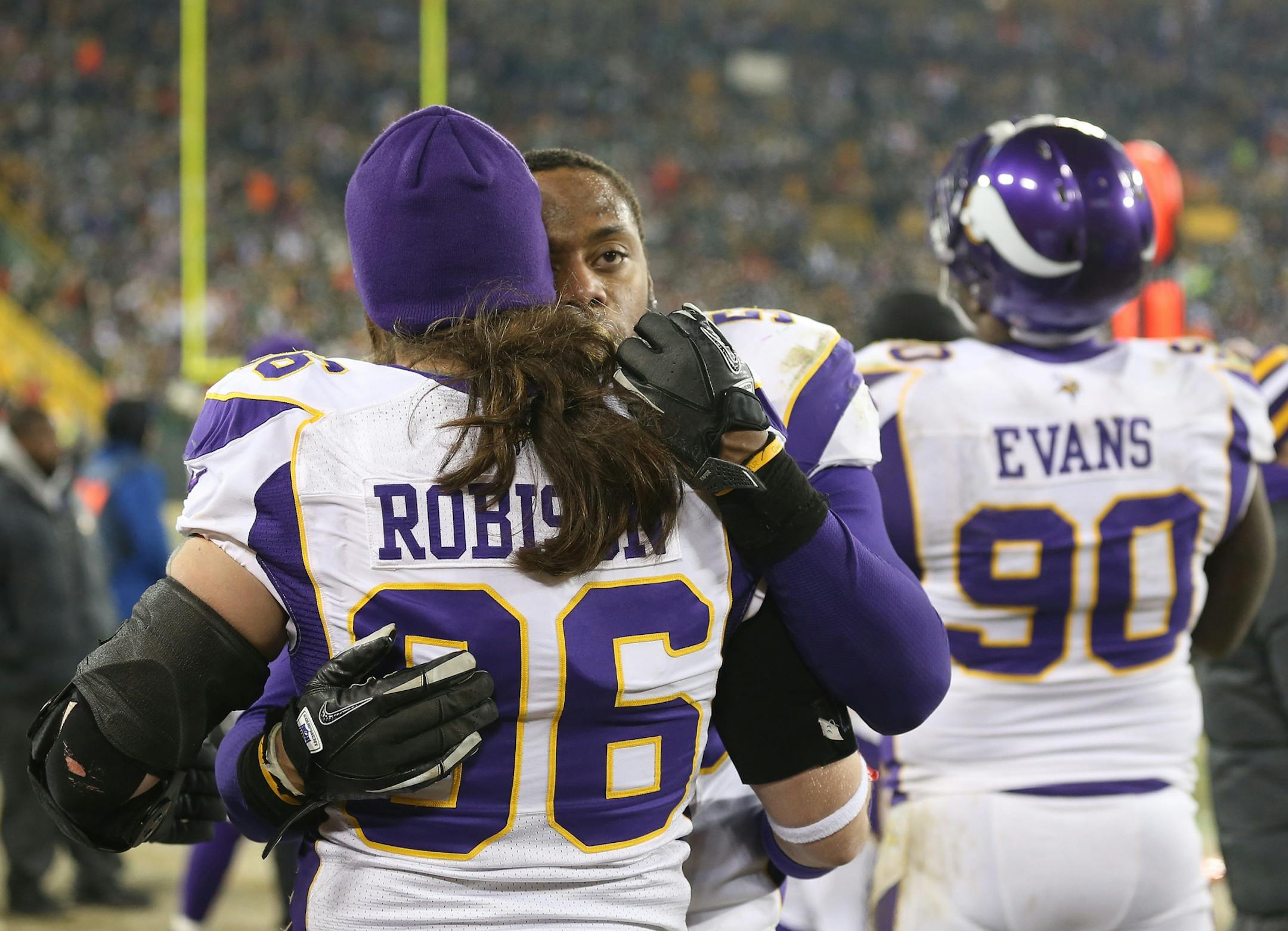 Erin Henderson hugged Brian Robison after the Vikings lost their wild card game against Green Bay.