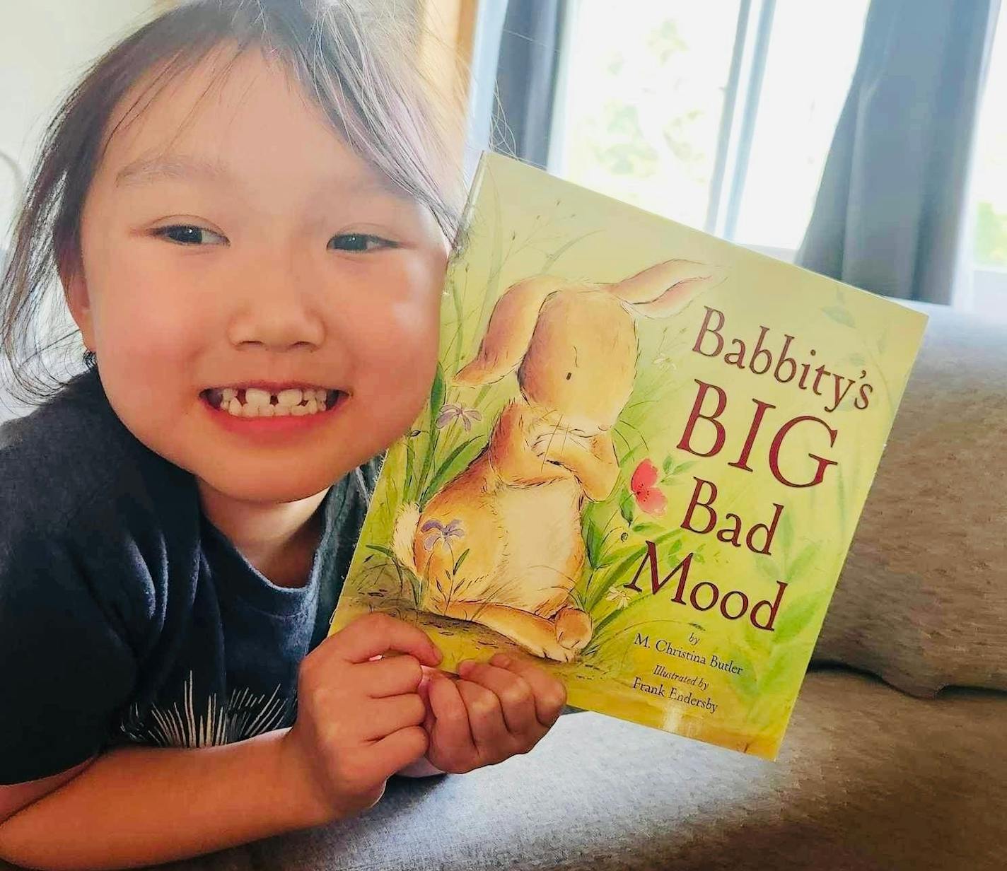 photo of Aubrey Vang with a book