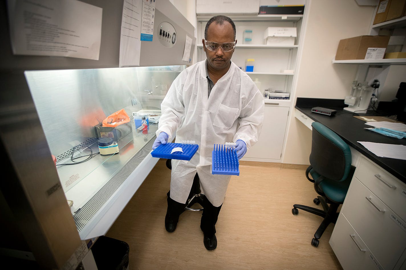 Netsanet Bekele, a clinical lab scientist for the Minnesota Health Department, tested for measles as he placed the tubes into a robot at the MHD laboratories in St. Paul on Thursday.