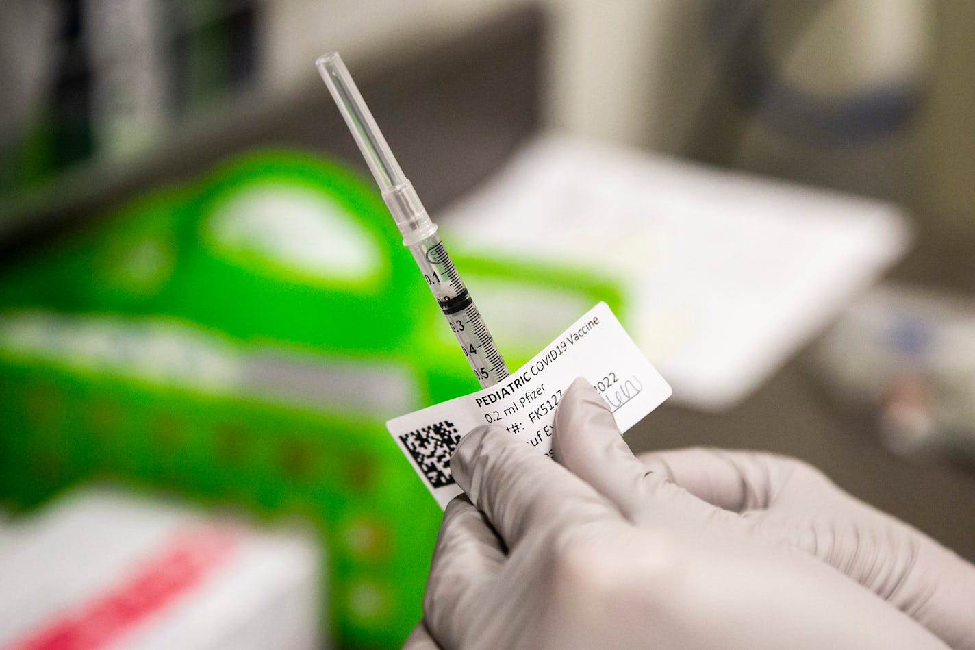 Jillian Berkan, a pharmacy resident at the University of Iowa Hospitals &amp; Clinics, places a label on a single dose of the Pfizer pediatric COVID-19 vaccine on the first day of a clinic for kids ages 5-11, Wednesday, Nov. 3, 2021, at the University of Iowa Health Care Iowa River Landing location in Coralville, Iowa. (Joseph Cress/Iowa City Press-Citizen via AP)