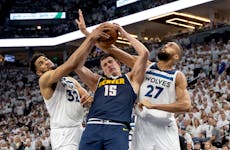 Wolves centers Karl Anthony Towns (32) and Rudy Gobert (27) try to defend against the many moves of three-time NBA MVP Nikola Jokic of the Nuggets in 