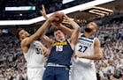 Wolves centers Karl Anthony Towns (32) and Rudy Gobert (27) try to defend against the many moves of three-time NBA MVP Nikola Jokic of the Nuggets in 