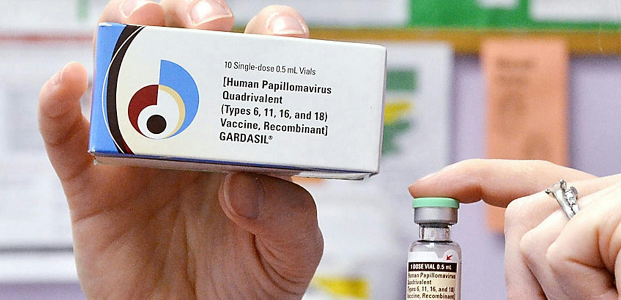 FILE - A child health nurse holds up a vial and box for the HPV vaccine, brand name Gardasil, at a clinic in Kinston, N.C. on Monday March 5, 2012. About 1 in 5 adolescent boys have rolled up their sleeves for a controversial vaccine designed to prevent cervical cancer in girls. The government on Thursday, Aug. 29, 2013 released teen vaccination rates for 2012 - the first full year since HPV shots were recommended for boys. (AP Photo/Daily Free Press, Charles Buchanan) ORG XMIT: NCKIN501