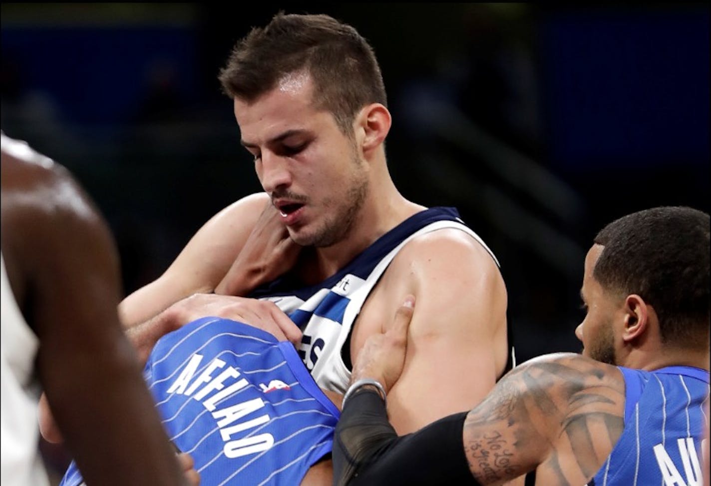 Orlando Magic's Arron Afflalo, left, gets into a fight with Minnesota Timberwolves' Nemanja Bjelica, center, as D.J. Augustin, right, comes in to help break it up during the first half of an NBA basketball game, Tuesday, Jan. 16, 2018, in Orlando, Fla. Afflalo and Bjelica were ejected from the game.