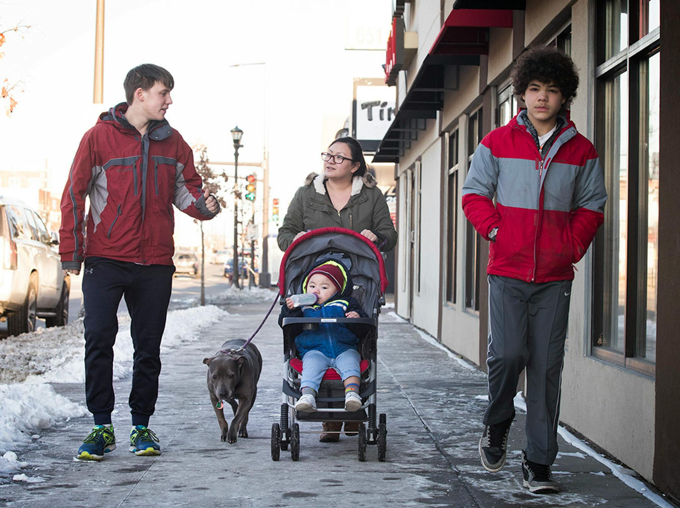 See Vue, center, with her 18-month-old son Raj and dog Ginger, takes a walk with Minnehaha Academy students Peter Shaffer, left, 14, and Daniel Rose, 14, on University Avenue in St. Paul. ] LEILA NAVIDI ï leila.navidi@startribune.com BACKGROUND INFORMATION: in St Paul on Wednesday, March 15, 2017. City Stay is an opportunity for Minnesota high school students to do home stays at the homes of other local residents. The cultural exchange program fosters new relationships among Minnesota's European