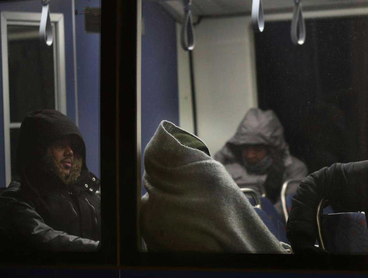 A rider is bundled up while resting on a blue line light rail train that was delayed at the Cedar Station Wednesday, Jan. 30, 2019, In Minneapolis, MN.